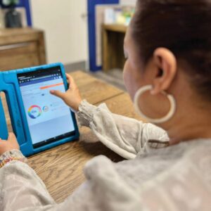 Teacher showcasing early education technology in Fueling Brains Academy Calgary Teacher showcasing early education technology in Fueling Brains Academy Calgary